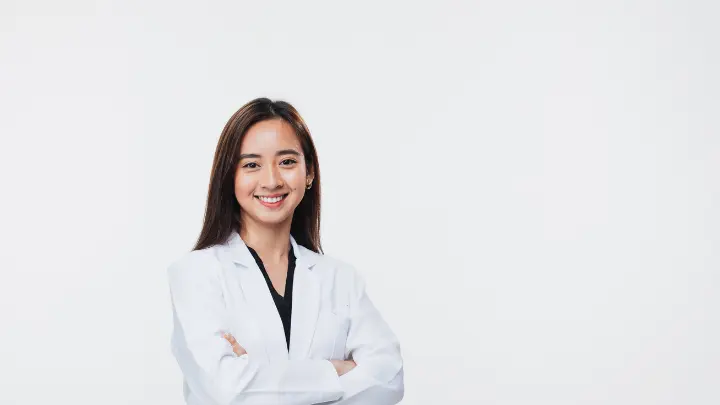 a dentist smilling with a white background