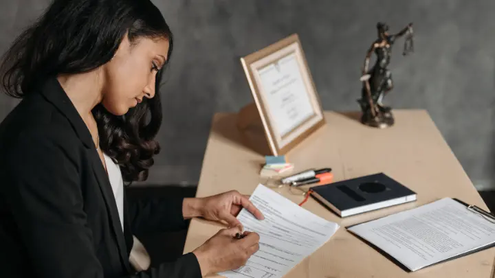 A female lawyer writing something down.