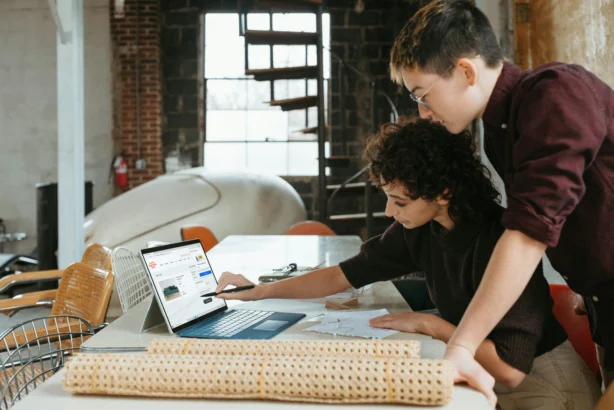 Two small business owners looking at data.