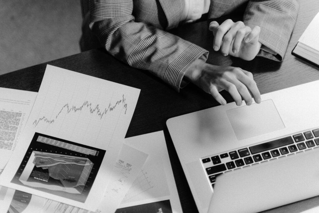 Grayscale Photo of Person Using a Macbook