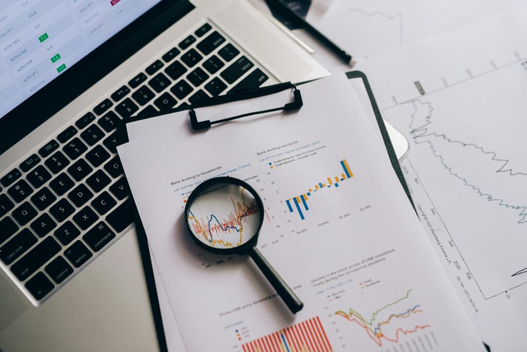 Magnifying Glass on White Paper with Statistical Data