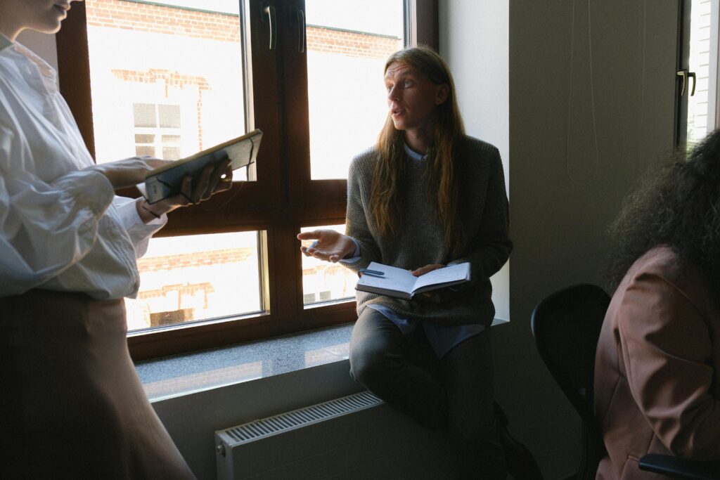 Man discussing project with colleague in office