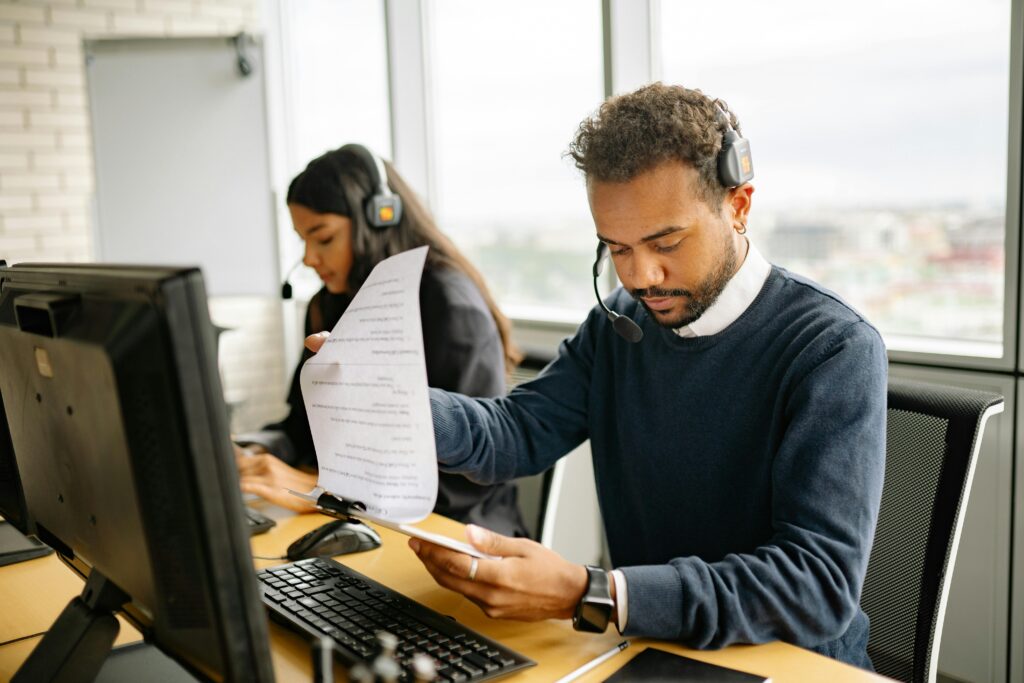 Man with Headphones Looking at a Document